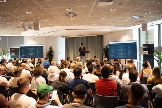 Sami on the Demo Stage at AI Summit Barcelona 2026, full room, workflow on both screens